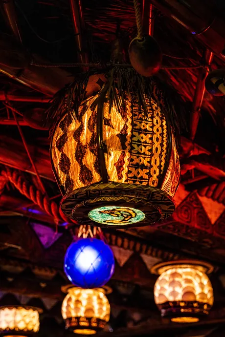 A glowing tiki lamp